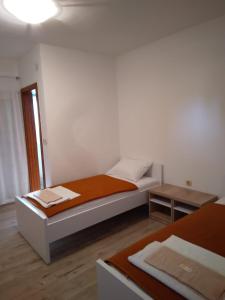 a small bedroom with a bed and a table at B&B Nikki in Međugorje