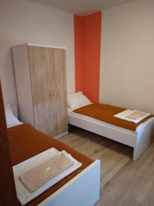 a small room with two beds and a cabinet at B&B Nikki in Međugorje