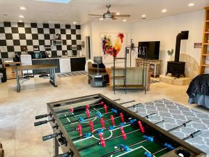 a room with a pool table in the middle of a living room at The Funky Chicken Hot Tub BBQ SLEEPS 4 in Ahwahnee
