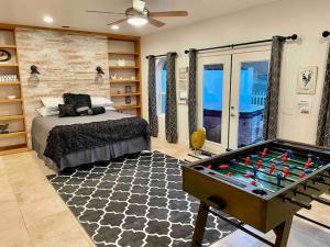 a bedroom with a bed and a pool table at The Funky Chicken Hot Tub BBQ SLEEPS 4 in Ahwahnee