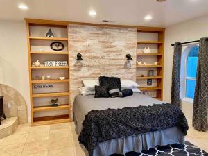 a bedroom with a bed and a wall with shelves at The Funky Chicken Hot Tub BBQ SLEEPS 4 in Ahwahnee +12 photos