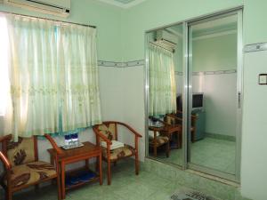 a room with chairs and a mirror and a desk at Kathy Hotel in Phan Thiet