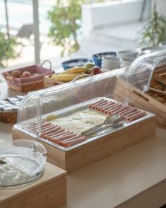 a tray of hot dogs and other food on a table at Akti Dimis Hotel in Tigaki