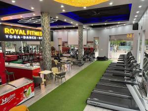 a restaurant with a gym with a green carpet at Royal Homestay - Royal Center in Móng Cái