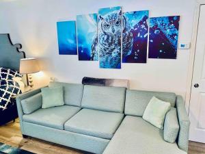 a living room with a blue owl painting on the wall at Owl Nest Hot Tub Sleeps 3 Yosemite in Ahwahnee +10 photos