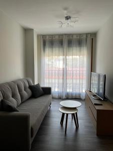 a living room with a couch and a table at Apartamento en Boiro in Escarabote