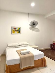 a bedroom with a bed and a fan at MOFA Homestay Near KLIA Airport in Sepang