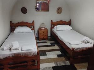two twin beds in a room with a table at Family house near the sea in Kokkala