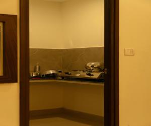 a kitchen with a counter with pots and pans at FLORA PAVILLION in Chennai