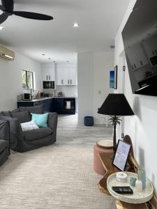 a living room with a couch and a table at Indigo Apartment with Pool 200m to Beach in Palm Cove