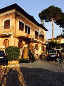 a house with cars parked in front of it at B&B Vittoria Colonna in Marino