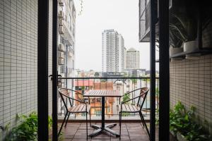 a table and chairs on a balcony with a view at ALEAH HOME in Hanoi