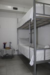 a bedroom with a bunk bed with white sheets at Hostel Near The Square in Tbilisi City