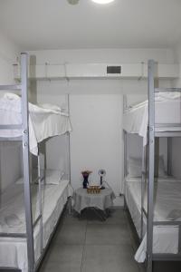 a room with three bunk beds and a table at Hostel Near The Square in Tbilisi City