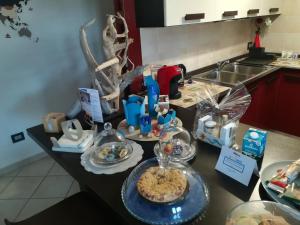 a kitchen counter with a table with food on it at SOLE e MARE Luxury Home in San Salvo