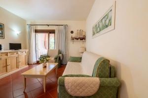 a living room with a couch and a table at [PORTO CERVO] Accanto alla spiaggia & vista Mare in Porto Cervo