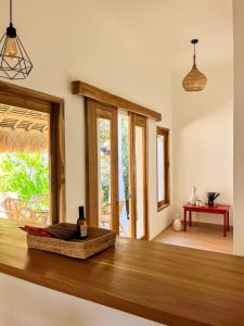 a kitchen with a wooden counter top with a window at Casa Flores in Kuta Lombok