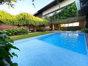 a swimming pool in the backyard of a house at Ocean Villa - Joshua District in Tabanan