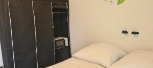 een kleine kamer met een bed en een televisie bij Lichtdurchflutetes Zimmer - Käppele in Waldbüttelbrunn