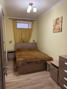 a bedroom with a large bed and a window at Appartment in the city center in Gyumri
