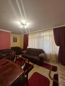a living room with a couch and a table at Appartment in the city center in Gyumri