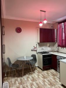 a kitchen with a table and a table and chairs at Appartment in the city center in Gyumri