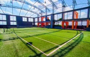a tennis court in a building with a lot of grass at Loft Suite Seaview near JB CIQ 8pax in Johor Bahru