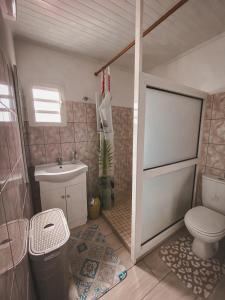 a small bathroom with a toilet and a sink at Gite les Bananiers in Saint-Joseph