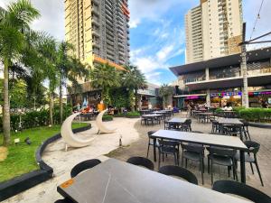a park with tables and chairs in a city at Loft Suite Seaview near JB CIQ 8pax in Johor Bahru