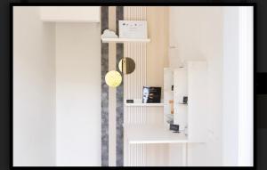 a room with a white refrigerator next to a door at B&B La Caruscia in Trivento