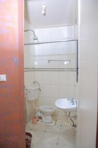a bathroom with a toilet and a sink at Perfect Motel in Kampala
