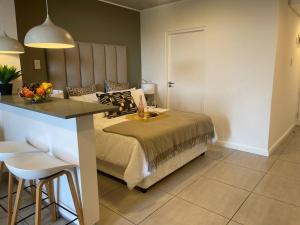 a bedroom with a bed and a table with a bowl of fruit at Luxury Beach Getaway@Coral Point in Sibaya