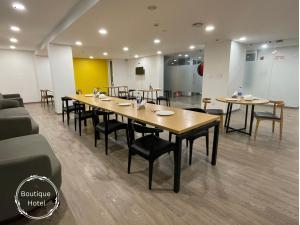 a conference room with a long table and chairs at Saltstayz Sector 39- Near Rajiv Chowk & Sohna Road in Gurgaon