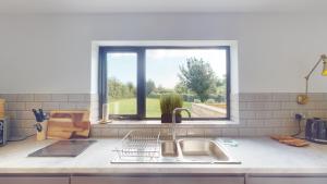 a kitchen counter with a sink and a window at Low Greenlands Holiday Park - Luxury House & Luxury Glamping Pods in Lancaster +65 photos
