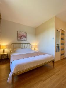 a bedroom with a large bed in a room at Aux Coteaux d'Aussac in L Honor De Cos +65 photos