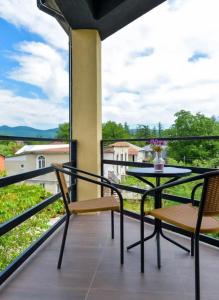 a balcony with a table and chairs and a view at Grand Central in Tsqaltubo