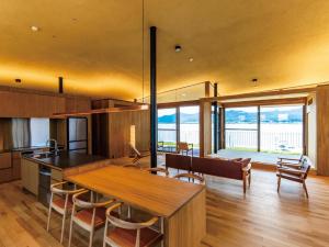 a kitchen with a table and chairs and a dining room at YANMAR SUNSET MARINA CLUBHOUSE&HOTEL in Moriyama