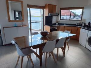 a kitchen with a dining room table and chairs at Sunset Villa in Langebaan