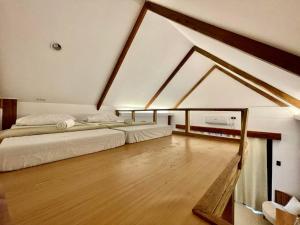 a bedroom with two beds in a attic at 89 Villas in El Nido