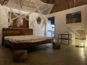 a bedroom with a bed with mosquito netting at Canopee Lodge in Nosy Komba