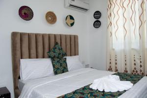 A bed or beds in a room at The Baobab Homestay