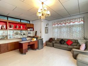 a large living room with a couch and a desk at Lotus House in Ban Lo Long