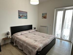 una camera con un grande letto e due finestre di Capo dei Bufali Alloggio turistico a Terracina