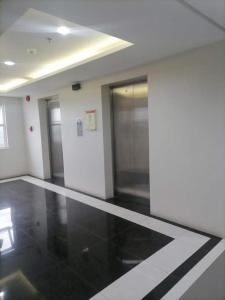 an empty room with black and white floors and glass doors at Condo for rent -The Loop Residences-relaxing , unique and satisfying in Cagayan de Oro