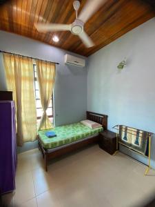 Cette chambre comprend un lit et une fenêtre au plafond. dans l'établissement Sri Panorama Home, à Kota Bharu