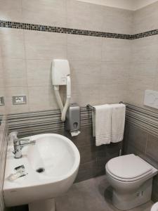 a bathroom with a sink and a toilet at Appartamenti Valdocco in Turin