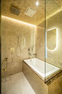 a bathroom with a tub and a glass shower at Ritz Residence @ Imago Loft B 7th Floor in Kota Kinabalu