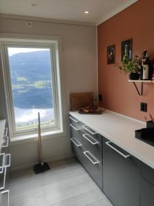 a kitchen with a large window and a counter at Modern family home in Voss in Vossevangen