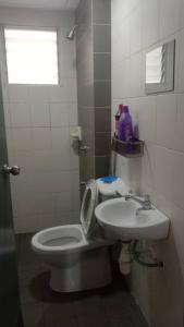 a bathroom with a toilet and a sink at PR1MA Presint 11 Putrajaya in Putrajaya