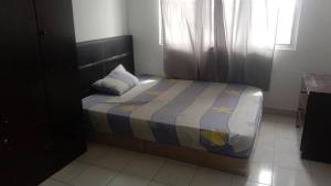 a small bed in a room with a window at PR1MA Presint 11 Putrajaya in Putrajaya